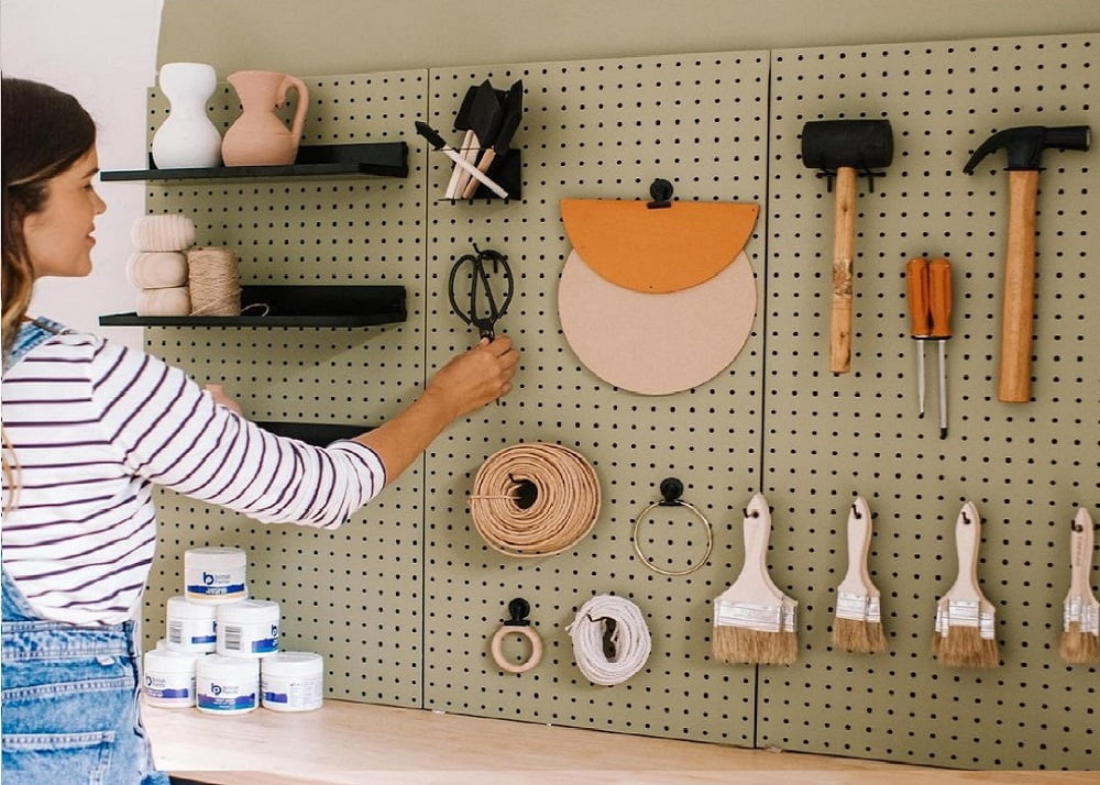 Tools and paint brushes hung on a custom-painted Pinnacle pegboard.